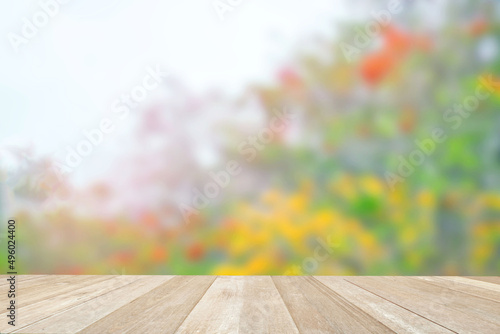 Empty top wooden table on soft focus blurred flowers in nature