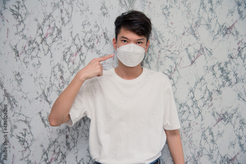 Man puts on a face mask elegant man wearing a mouth protection to prevent getting sick at work or on the way to work  isolated on White background,pandemic and social distancing concept.Covid-19