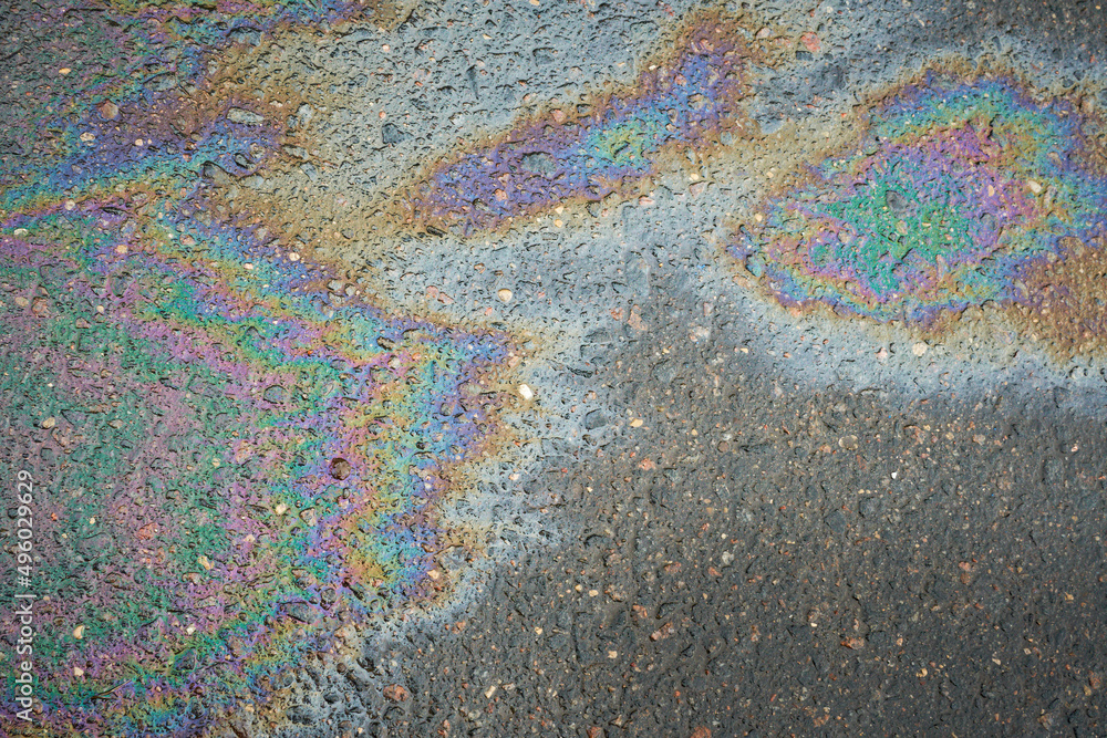 Oil slick on the asphalt road background