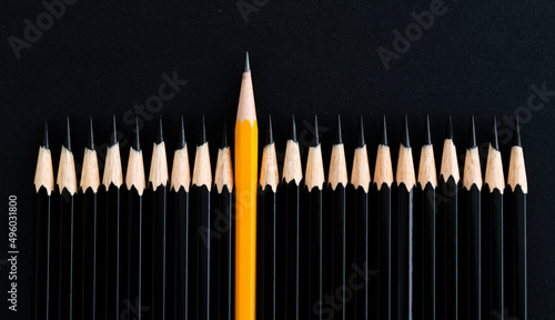 Yellow pencil standing out from the crowd