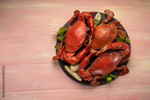 Steamed Red Crab on black plate , Boiled Sea crab on wooden background.