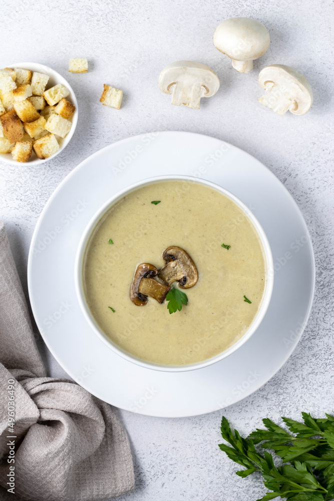 Mushroom cream soup with parsley and croutons on a dark grey, top view. Selective focus. Mushroom cream soup with parsley and croutons on a dark grey, top view. Selective focus.