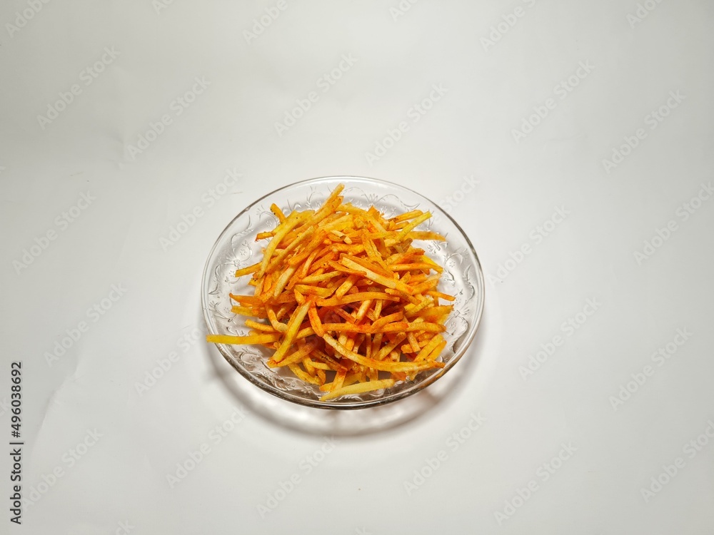 Slices of fried potatoes sprinkled with savory balado seasoning