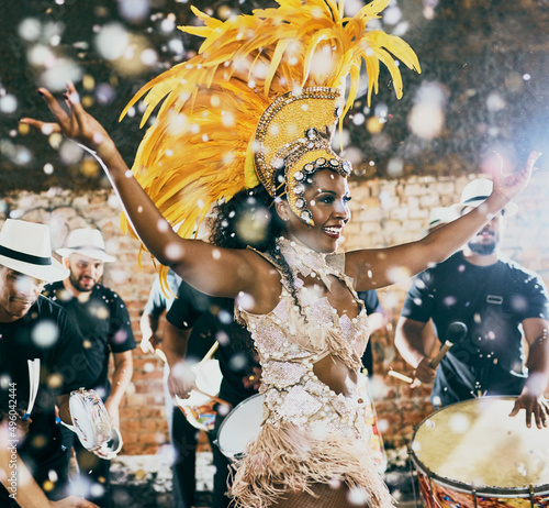 Our night to shine. Cropped shot of a beautiful samba dancer performing in a carnival with her band. photo