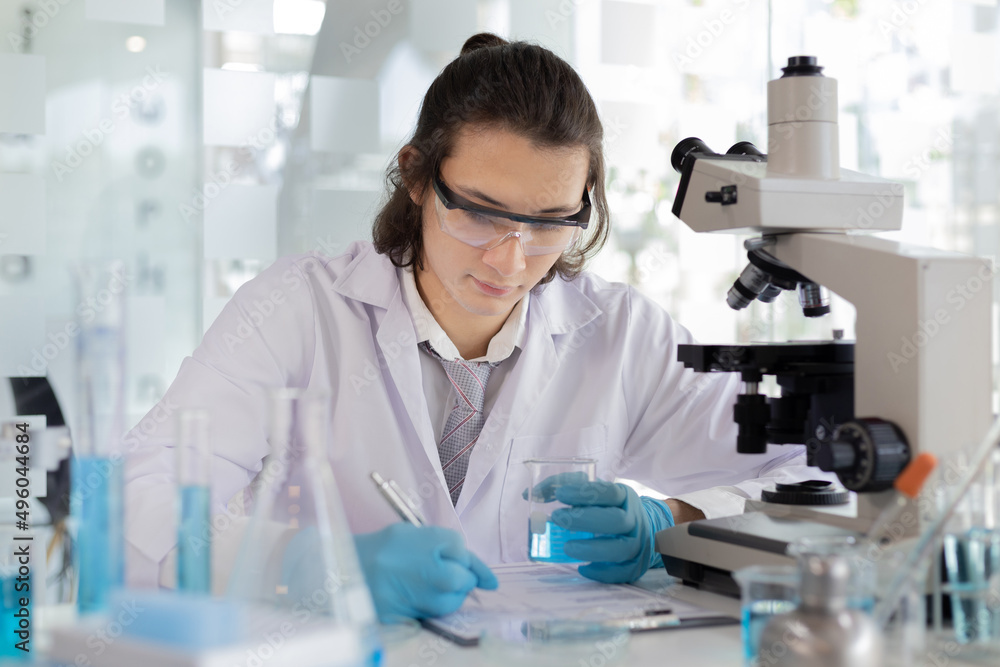 Laboratory diagnosis of synthetic substances, Scientist or researcher examines the substance in vitro and record information, Lab experiments, Researchers scientist working analysis with test tube. Laboratory diagnosis of synthetic substances, Scientist or researcher examines the substance in vitro and record information, Lab experiments, Researchers scientist working analysis with test tube.