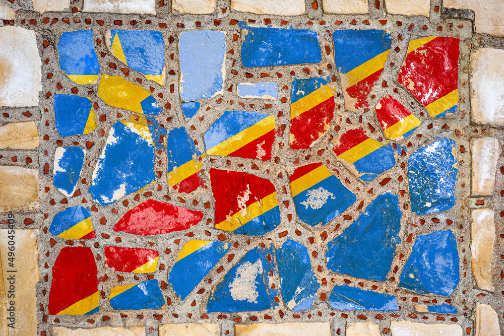 National flag of Democratic Republic of the Congo on stone wall background. Flag banner on stone texture background. National flag of Democratic Republic of the Congo on stone wall background. Flag banner on stone texture background.