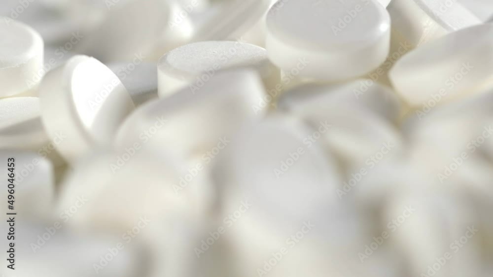 The medicine concept.white medical pills rotating closeup. Pills and drugs. Pharmaceutical Industry. drugs on the production line. moving background. close-up. view from above.super slow motion The medicine concept.white medical pills rotating closeup. Pills and drugs. Pharmaceutical Industry. drugs on the production line. moving background. close-up. view from above.super slow motion
