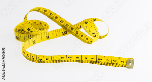 Yellow measuring tape on white background