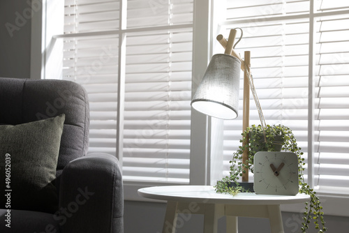 Room interior with stylish lamp and furniture