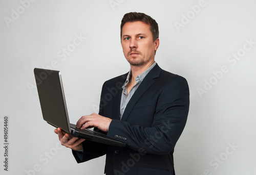 Young businessman using laptop computer on white background