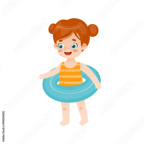 Cute little girl with inflatable ring. Adorable red hair baby girl standing with swimming circle.