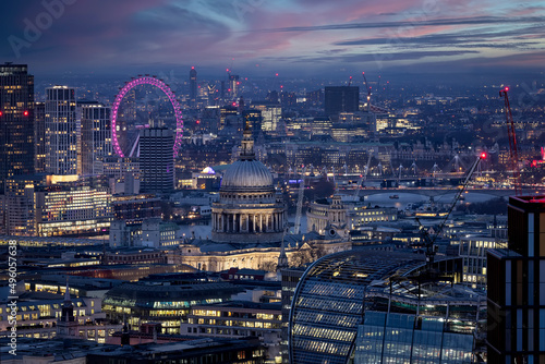 Elevated, panoramic view of the illuminated skyline of London with St. Pauls Cathedral and Westminster district