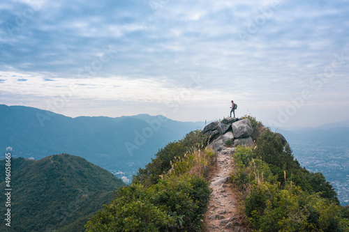 Man standing on peak of mountain, alone hiker, countryside near Fanling Hong Kong photo