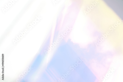 blurred soft rainbow light flares background or overlay. double exposure. blurry reflection of the sky in the window photo