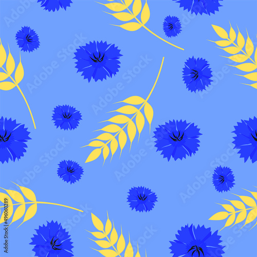 Cornflowers and wheat, seamless texture on a blue background. Wheat spikelets and meadow flowers.