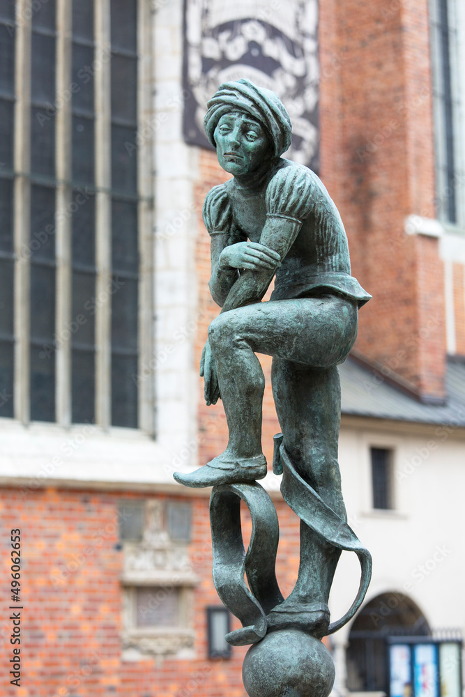 Naklejka premium Figurine student, a copy of the form from the altar of Veit Stoss, fountain in the square of St. Mary's, Krakow, Poland