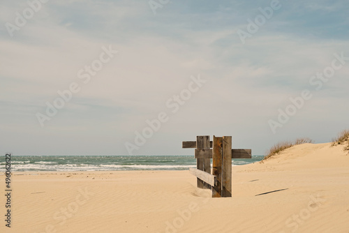 Landscape of sand dune system on the beach at noon, sea coast. Desert dunes on the Black Sea coast, sky with feather clouds, pastel colors