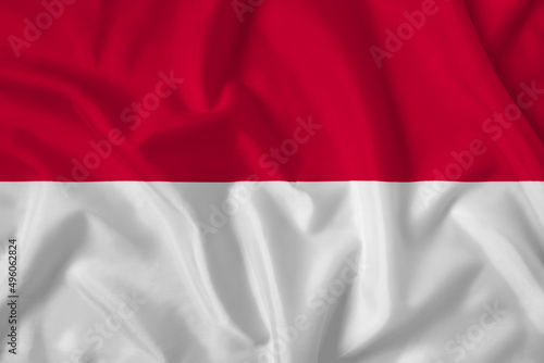 Monaco flag with fabric texture. Close up shot, background