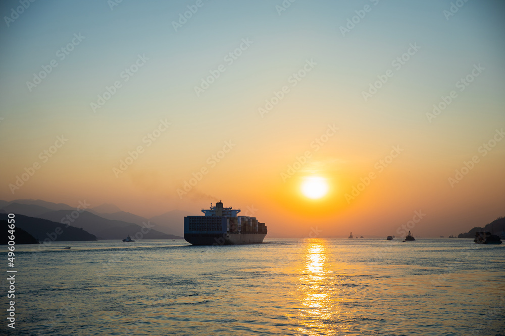 Cargo Carrier sailing in ocean, sunset moment Cargo Carrier sailing in ocean, sunset moment