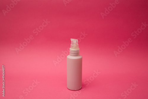 Jar with antiseptic on a pink background