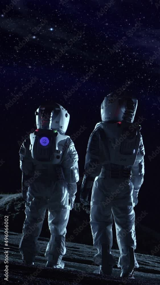 Two Astronauts in Space Suits Standing on the Alien Planet Look at Dark ...