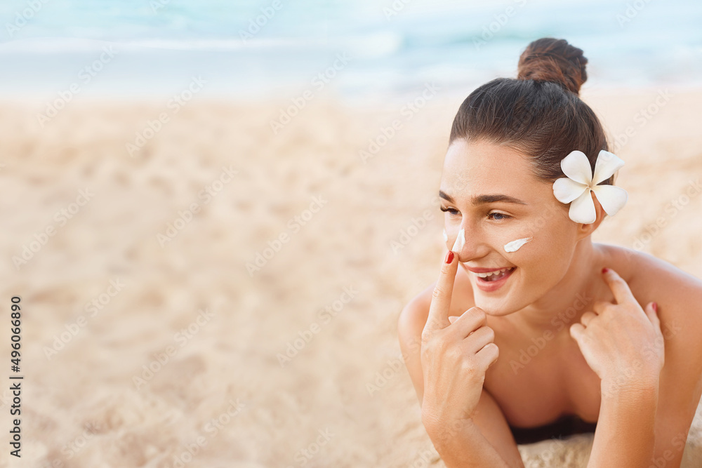 Beautiful Woman In Bikini apply sun cream on Face. Woman With Suntan Lotion On Beach. Skin care. Sun protection. Beautiful Woman In Bikini apply sun cream on Face. Woman With Suntan Lotion On Beach. Skin care. Sun protection.