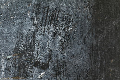 Distressed grunge textured dark gray antique concrete wall surface with spots for texture background