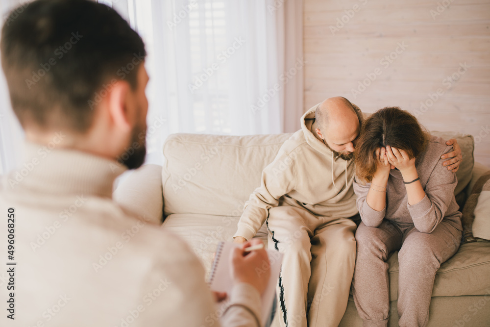 Psychiatrist consulting couple that have problems in their relationship. Mental support session. Psychiatrist consulting couple that have problems in their relationship. Mental support session.