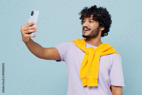 Photography Fascinating young bearded Indian man 20s years old wears white t-shirt do selfie shot on mobile cell phone post photo on social network isolated on plain pastel light blue background studio portrait