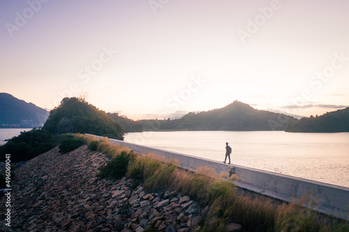 Man walking alone the dam, evening of Plover Cove Reservoir, Hong Kong