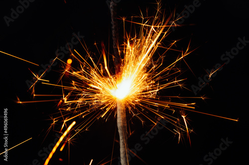 Close view of sparkler on black background. soft selective focus. abstract bokeh background  copy space. Christmas or New Year composition. Christmas card.