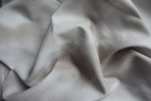 Crumpled viscose and polyester fabric with tie dye pattern in shades of gray