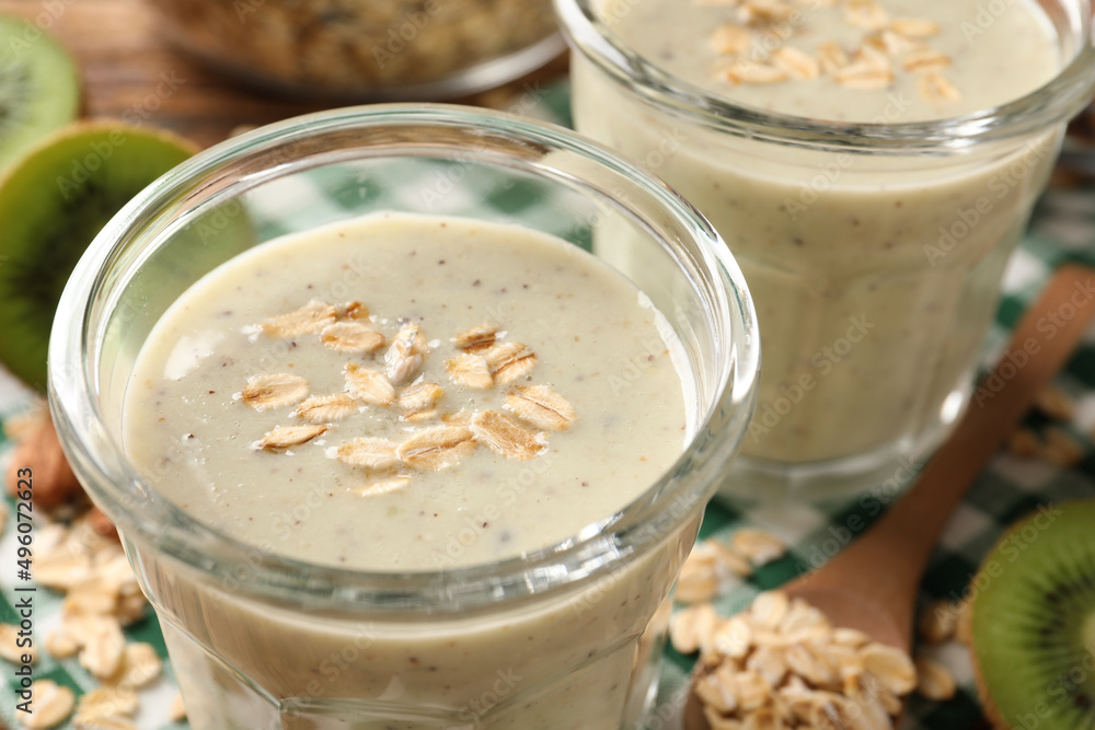 Tasty kiwi smoothie with oatmeal on table, closeup Tasty kiwi smoothie with oatmeal on table, closeup