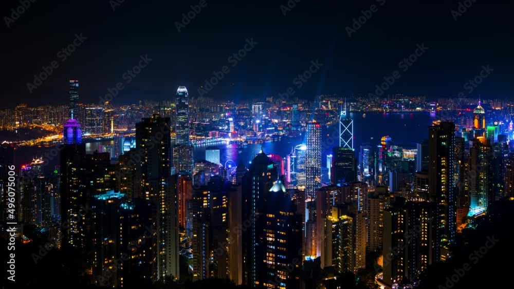 Hong Kong at night. Skyline of Hong Kong at night. Illuminated skyscrapers with dark sky and river. Time-lapse from evening to night Hong Kong at night. Skyline of Hong Kong at night. Illuminated skyscrapers with dark sky and river. Time-lapse from evening to night