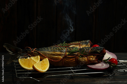 Concept of tasty food with smoked mackerel on wooden table