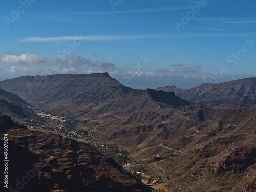 Aerial panoramic view of the south of island Gran Canaria, Spain in the Atlantic Ocean on sunny day with village Mogan surrounded by rugged mountains.