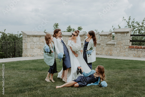 Cute bridesmaids in the stylish dresses and a bride