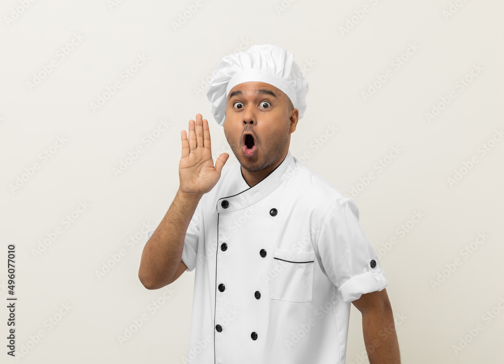 Wow excited face Young handsome asian man chef in uniform with hat standing posting looking camera on isolated. Cooking indian man Occupation chef People in kitchen restaurant and hotel. Wow excited face Young handsome asian man chef in uniform with hat standing posting looking camera on isolated. Cooking indian man Occupation chef People in kitchen restaurant and hotel.