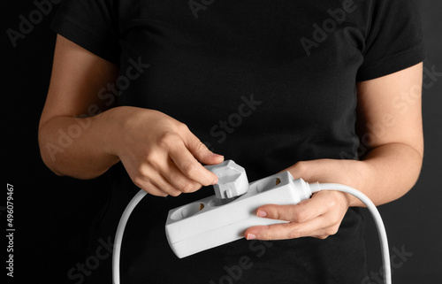 Fotografi electricity, energy and power consumption concept - close up of woman inserting