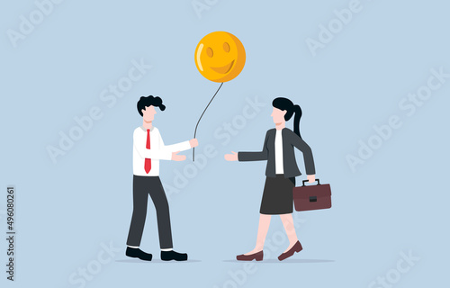 Sharing positive energy between workmates, making positive vibe in workplace, or giving happiness to release stress from work concept. Businessman giving happy face balloon to coworker.