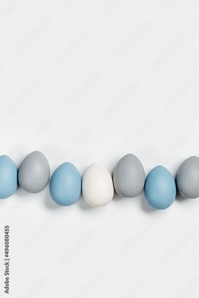 Painted Easter eggs blue, gray colored in row on white background with copy space. Chicken egg natural pastel shades. Easter holiday food, minimal design aesthetic flat lay Painted Easter eggs blue, gray colored in row on white background with copy space. Chicken egg natural pastel shades. Easter holiday food, minimal design aesthetic flat lay