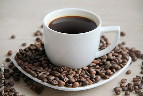 Coffee cup with coffee beans close up