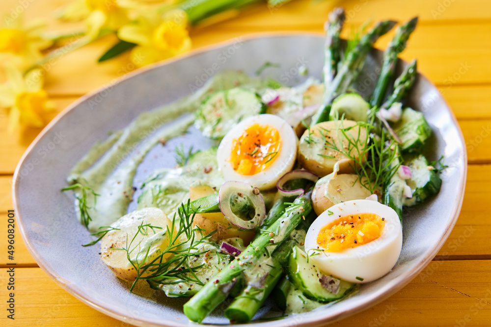 Tasty vegetable salad with eggs and asparagus in bowl