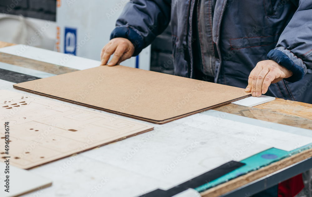 Carpenter making wooden puzzles. Woodwork for puzzle, closr up Carpenter making wooden puzzles. Woodwork for puzzle, closr up