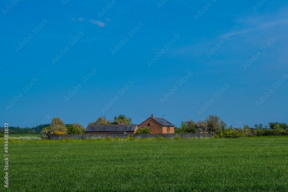 Lush green farming land - farmhouse house Warwickshire England UK