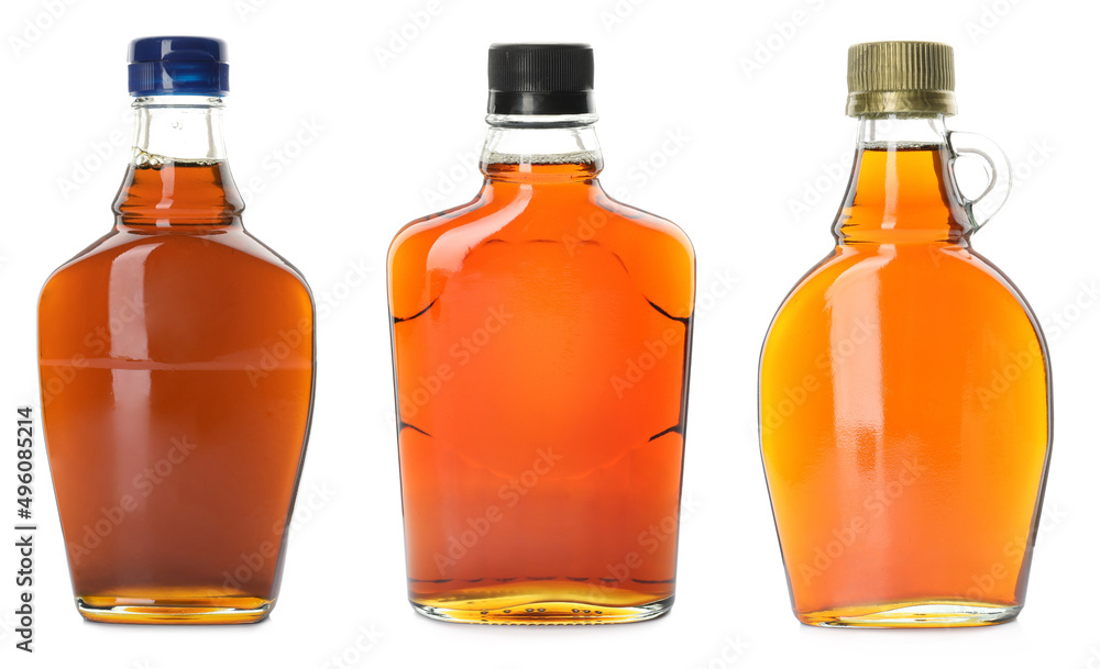 Set with bottles of tasty maple syrup on white background Set with bottles of tasty maple syrup on white background