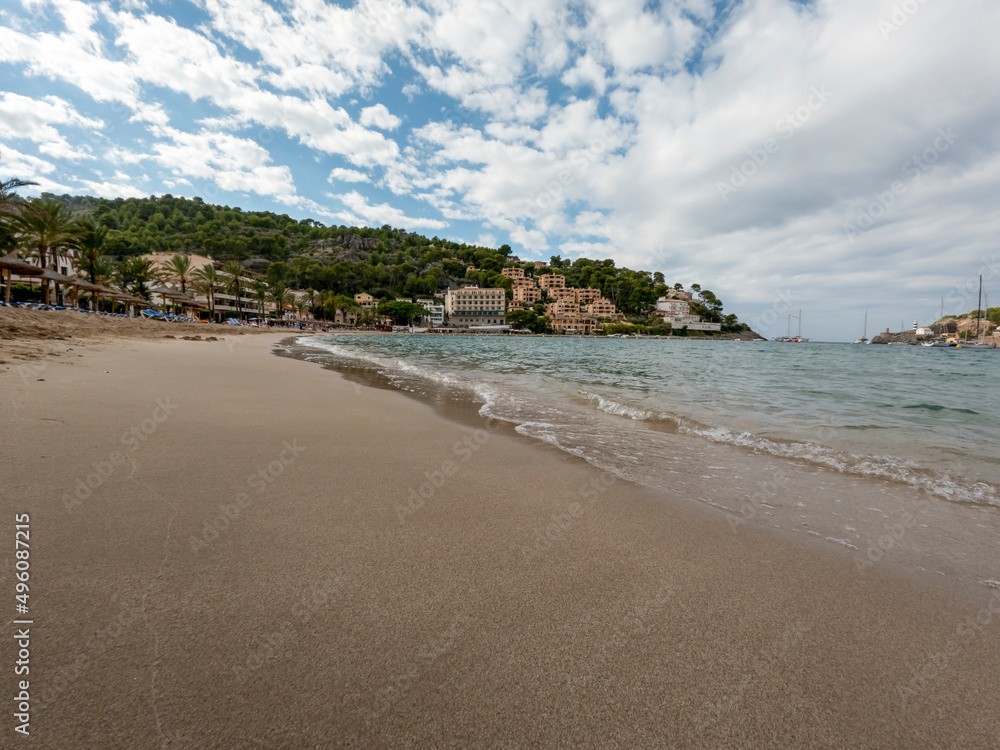 Sandy beach landscape of Meditteranean sea coast and mountain background in Port de Soller, Palma de Mallorca, Spain, Europe