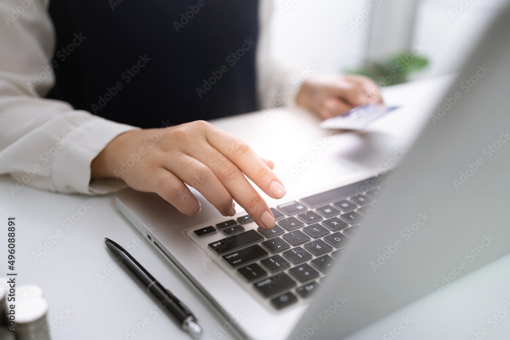 Woman holding credit card and using laptop computer for Internet online e-commerce shopping spending money Online shopping laptop technology concept . Online shopping pay by credit card concept Woman holding credit card and using laptop computer for Internet online e-commerce shopping spending money Online shopping laptop technology concept . Online shopping pay by credit card concept