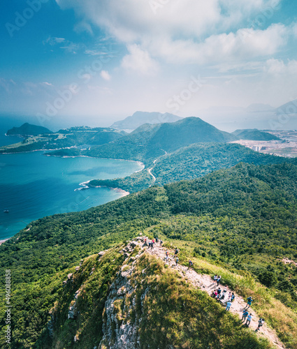 People walking on Footpath on a sharp mountain in Clear Water Bay, Sai Kung, Hong Kong. Hiking destination, clear weather in Autumn, Epic View
