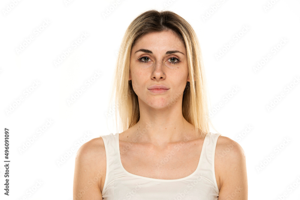 Portrait of a young woman without makeup on a white background Portrait of a young woman without makeup on a white background